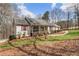 Well-maintained home with a welcoming front porch, complemented by green lawn and mature trees, creating a serene setting at 4150 E Chapel Hill Rd, Douglasville, GA 30135