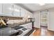 Bright kitchen featuring tile backsplash, ample counter space and a window overlooking backyard at 4150 E Chapel Hill Rd, Douglasville, GA 30135