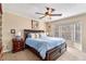 Spacious main bedroom featuring a ceiling fan, neutral carpet, and a sunny bay window at 4150 E Chapel Hill Rd, Douglasville, GA 30135