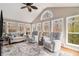 Cozy sunroom featuring hardwood flooring, comfortable seating, and serene wooded views at 4150 E Chapel Hill Rd, Douglasville, GA 30135