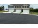 Three townhomes each with a white garage door and neutral color scheme at 8660 Webb Rd, Riverdale, GA 30274