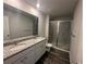 Bathroom with double vanity, granite counter, and glass shower doors at 8664 Webb Rd, Riverdale, GA 30274