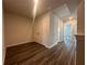 Hallway with wood floors, white walls, and two-door storage closet at 8664 Webb Rd, Riverdale, GA 30274
