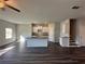 A well-lit open-concept kitchen and living area features a ceiling fan and hardwood floors at 8664 Webb Rd, Riverdale, GA 30274