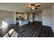 Bright open-concept kitchen and living room featuring hardwood floors, a ceiling fan and granite countertops at 8664 Webb Rd, Riverdale, GA 30274