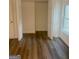 Spacious bedroom featuring hardwood floors and a double-door closet for ample storage at 103 Tiburon Ct, Stonecrest, GA 30038