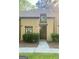 Inviting townhouse exterior with lush greenery, a paved walkway, and a well-maintained front facade at 103 Tiburon Ct, Stonecrest, GA 30038