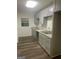 View of the kitchen featuring gray cabinets, gray counter tops and wood-look flooring at 103 Tiburon Ct, Stonecrest, GA 30038