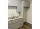 View of the kitchen featuring gray cabinets, gray counter tops and double sink at 103 Tiburon Ct, Stonecrest, GA 30038