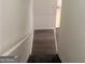 Minimalist staircase with neutral walls, dark wood treads, and a white handrail offers a sleek design at 103 Tiburon Ct, Stonecrest, GA 30038