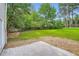 Expansive backyard with a concrete patio and lush green grass at 1070 Evergreen Oak Way, Dacula, GA 30019
