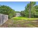 A spacious backyard features mature trees and lush green grass at 1070 Evergreen Oak Way, Dacula, GA 30019