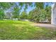 A sprawling green backyard is surrounded by mature trees and a wood fence at 1070 Evergreen Oak Way, Dacula, GA 30019