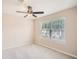 Neutral bedroom with a large window with a view and a ceiling fan at 1070 Evergreen Oak Way, Dacula, GA 30019