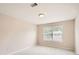 Neutral bedroom with a large window providing natural light at 1070 Evergreen Oak Way, Dacula, GA 30019