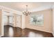 Dining room featuring hardwood floors, natural light, and a view to another living space at 1070 Evergreen Oak Way, Dacula, GA 30019