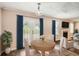 Dining Room featuring windows, a door to the yard, and a view of the fireplace at 1070 Evergreen Oak Way, Dacula, GA 30019