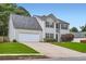 Charming two-story home featuring stone accents, manicured lawn, and an attached two-car garage at 1070 Evergreen Oak Way, Dacula, GA 30019