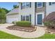 Charming home featuring stone accents, manicured lawn, and an attached two-car garage at 1070 Evergreen Oak Way, Dacula, GA 30019