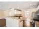 Open kitchen layout with counter seating and view to a dining area at 1070 Evergreen Oak Way, Dacula, GA 30019