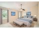 Cozy main bedroom featuring neutral decor, ceiling fan, and two windows at 1070 Evergreen Oak Way, Dacula, GA 30019