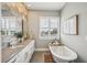 Elegant bathroom featuring double sink vanity, hexagon tile accent wall and a clawfoot soaking tub at 206 Ne 11Th Ne St # 703A, Atlanta, GA 30309