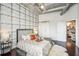 Comfortable bedroom with accent wall, modern lamps, and access to the Primary bathroom at 206 Ne 11Th Ne St # 703A, Atlanta, GA 30309