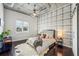 Cozy bedroom features industrial accents, a ceiling fan, and a large window at 206 Ne 11Th Ne St # 703A, Atlanta, GA 30309