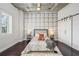 Stylized bedroom offers modern lighting, a sliding barn door, and polished concrete ceiling at 206 Ne 11Th Ne St # 703A, Atlanta, GA 30309