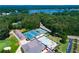 Aerial view showcases community amenities including tennis courts and a pool surrounded by green trees and a scenic lake at 8088 Lakeview Pkwy, Villa Rica, GA 30180