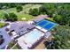 Aerial of a community clubhouse featuring a pool, tennis courts, and beautifully landscaped grounds for leisure and recreation at 8088 Lakeview Pkwy, Villa Rica, GA 30180