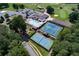 Aerial view highlighting community amenities with tennis courts and a pool area next to a golf course at 8088 Lakeview Pkwy, Villa Rica, GA 30180