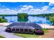 An aerial view captures the community clubhouse, a beach, picnic tables, and calm water at 8088 Lakeview Pkwy, Villa Rica, GA 30180