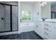 Bathroom with glass shower, soaking tub, and modern finishes at 8088 Lakeview Pkwy, Villa Rica, GA 30180