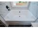 Close-up of soaking tub with modern fixtures and marble surround at 8088 Lakeview Pkwy, Villa Rica, GA 30180