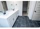 Bathroom featuring a double sink vanity with sleek fixtures and a view into the walk-in closet at 8088 Lakeview Pkwy, Villa Rica, GA 30180