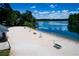 View of a lakefront beach with lifeguard chairs, picnic tables and calm water at 8088 Lakeview Pkwy, Villa Rica, GA 30180