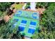 Aerial view showcases well-maintained basketball and tennis courts nestled in the woods at 8088 Lakeview Pkwy, Villa Rica, GA 30180