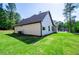 A view of the backyard with an air conditioning unit and lush greenery at 8088 Lakeview Pkwy, Villa Rica, GA 30180