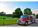 View of a red firetruck parked next to a lush golf course on a clear day at 8088 Lakeview Pkwy, Villa Rica, GA 30180