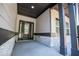 Inviting front porch with stone accents, dark trim, and a modern front door at 8088 Lakeview Pkwy, Villa Rica, GA 30180
