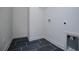 A modern laundry room featuring a slate floor and neutral walls at 8088 Lakeview Pkwy, Villa Rica, GA 30180