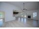 Bright living room featuring light flooring, fireplace, and seamless access to the kitchen at 8088 Lakeview Pkwy, Villa Rica, GA 30180