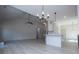 Bright living room with modern flooring, fan, and an open layout to the kitchen and dining area at 8088 Lakeview Pkwy, Villa Rica, GA 30180