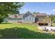 View of the house from the large backyard, showcasing the back deck and well-maintained lawn at 1490 Twin Manor Dr, Loganville, GA 30052