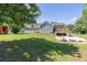 Exterior view of the house from the spacious backyard with mature trees and lush greenery at 1490 Twin Manor Dr, Loganville, GA 30052