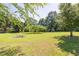 Spacious backyard featuring a fire pit and lush greenery for outdoor enjoyment at 1490 Twin Manor Dr, Loganville, GA 30052
