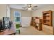 Bright bedroom with natural light, carpet, ceiling fan, and furnishings at 1490 Twin Manor Dr, Loganville, GA 30052