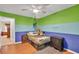 Spacious bedroom with wood floors, ceiling fan and colorful decor at 1490 Twin Manor Dr, Loganville, GA 30052