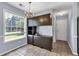Cozy dining area with built-in cabinets, chandelier lighting, and natural light from a large window at 1490 Twin Manor Dr, Loganville, GA 30052